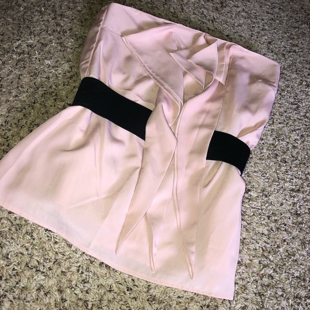 Light pink strapless blouse with a black band.
